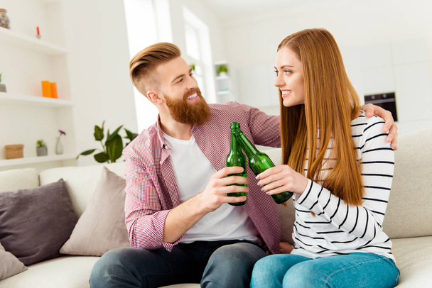 Fun soccer hooray yeah yes date bonding partners concept. Excited attractive cheerful rejoicing delightful funny funky glad friends clinking bottles sitting on divan watching tv on holidays vacation - Fotografie, Obrázek