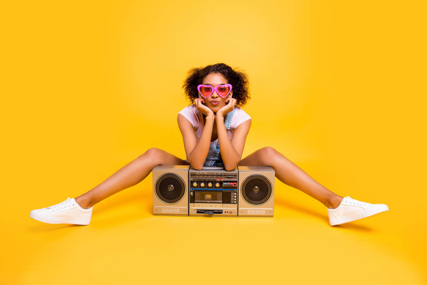 Portrait of sexy charming girlfriend in eyewear having boom box sending kiss with pout lips at camera isolated on yellow background. Leisure rest relax concept - Fotoğraf, Görsel
