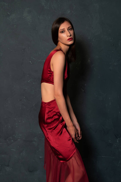 Tall slender Ukrainian brunette in a bright red dress - 写真・画像
