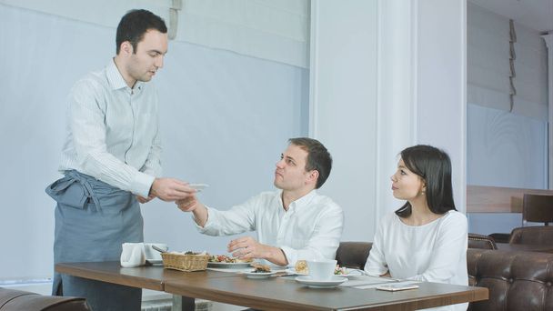 Young couple not liking their food and asking waiter to take it away - Photo, Image