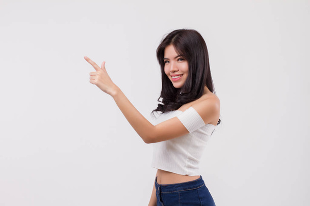 happy smiling woman pointing up portrait, positive optimistic woman point finger or hand studio white isolated portrait, young adult beautiful girl asian woman model - Foto, imagen