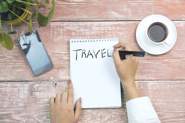 woman writing travel word on notebook - Foto, imagen
