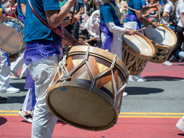 A mexican marching band beats on drums while walking down streets of Carnaval festival - Photo, Image