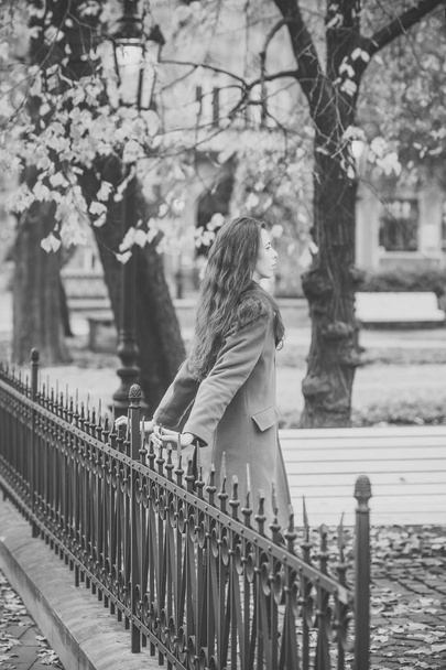 Woman waits her boyfriend in park. Beauty, dating, town, waiting, walk concept. - Photo, Image