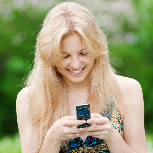 Woman texting on mobile phone - Photo, Image