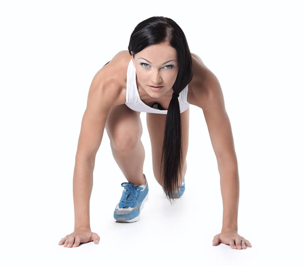 Attractive fitness woman doing low start cross fit exercises - Foto, afbeelding