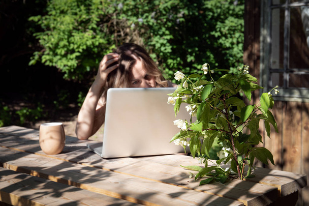 Job with computer outdoors by wooden table at country, work from home - Foto, Imagem