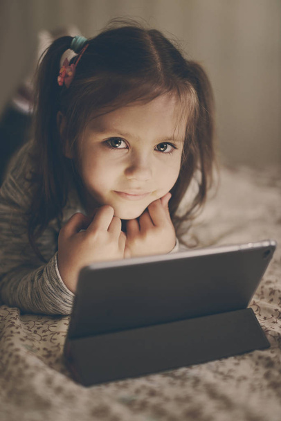 little girl with tablet pc at home - Foto, Bild