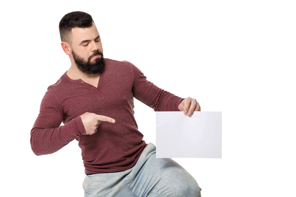 bearded man holding white card. - Фото, изображение