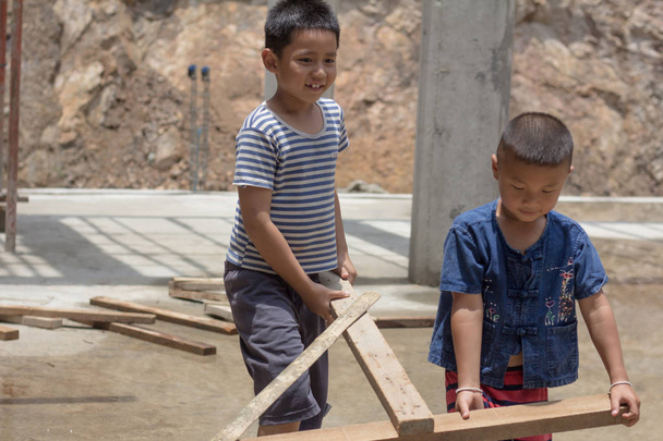 Two children were forced to work on construction because of poverty. Violence children and trafficking concept,Anti-child labor, Rights Day on December 10. - Photo, Image