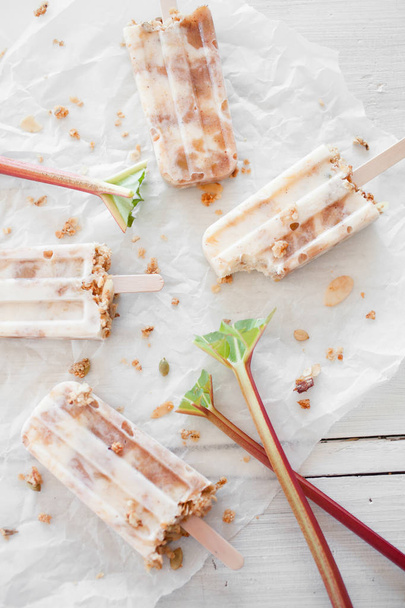 Homemade popsicles with rhubarb, yogurt and granola - Photo, image