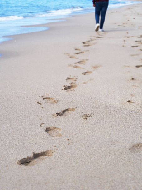 Huellas de una persona caminando en la playa tranquilamente y disfrutando de un buen día
 - Foto, imagen