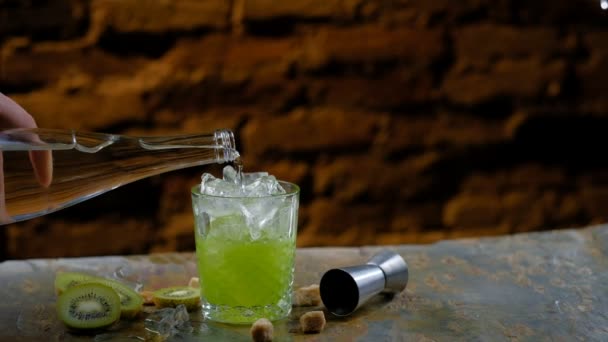 Barman hand pouring alcohol into glass - Кадри, відео