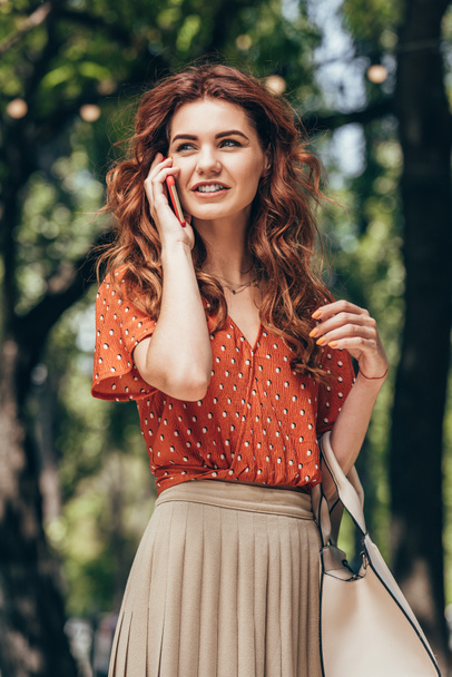 portrait of young beautiful woman talking on smartphone on street - Photo, Image