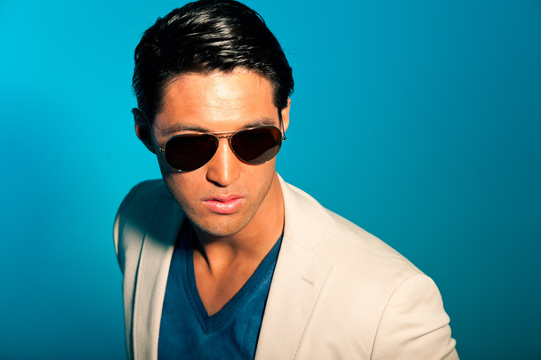 Asian man wearing suit and sunglasses. Summer fashion. Studio. - Fotó, kép