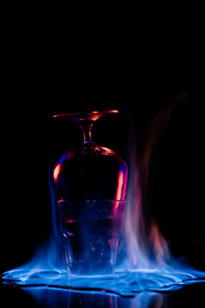 close up view of glasses and burning sanbuca alcohol drink around on black background - Photo, Image