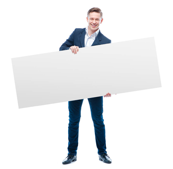 Handsome young business man holding big blank with copy space - Photo, Image
