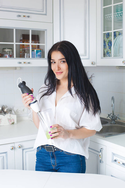 Attractive woman making smoothie indoors - Photo, Image
