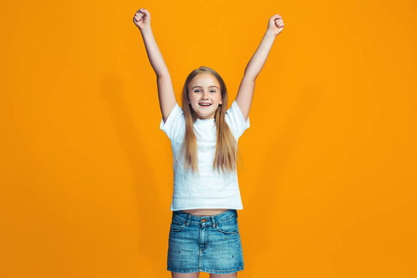 Happy success teen girl celebrating being a winner. Dynamic energetic image of female model - Foto, afbeelding