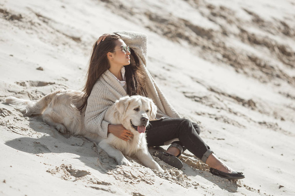 Dog owner with her pet spending time outdoors - Fotó, kép