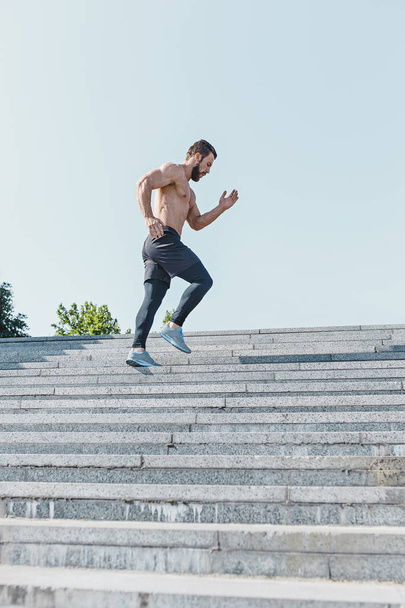 Fit man doing exercises outdoors at city - Fotografie, Obrázek