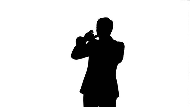 Silhouette Portrait of a young man playing his Trumpet - Фото, изображение
