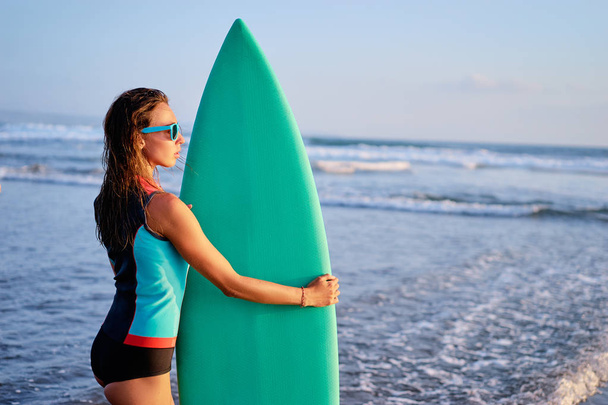 Portret surfer. Młoda kobieta, deska surfingowa gospodarstwa. - Zdjęcie, obraz