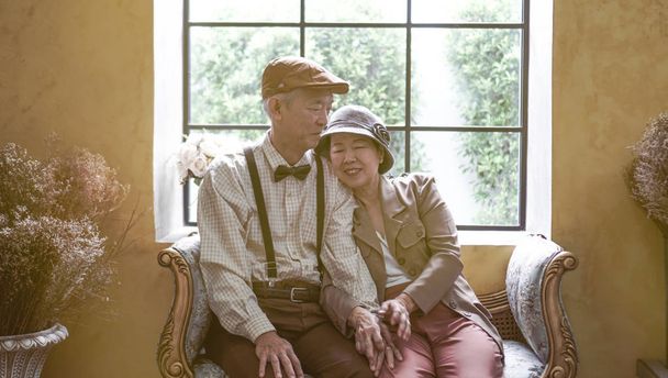 Asian senior couple dress vintage retro style in luxury house with tuscan style yellow wall - Фото, изображение