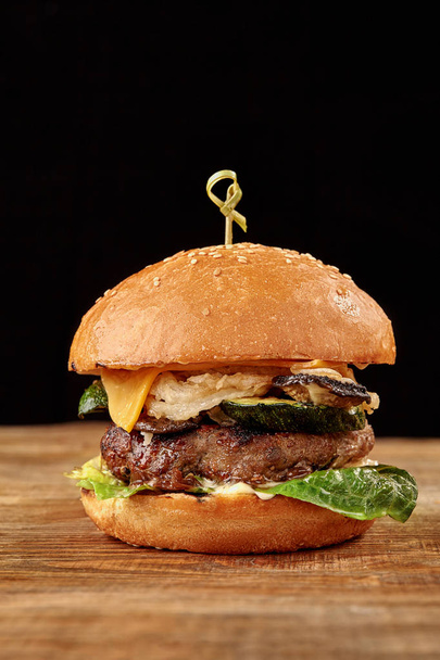 Fresh tasty burger on black background - Photo, Image