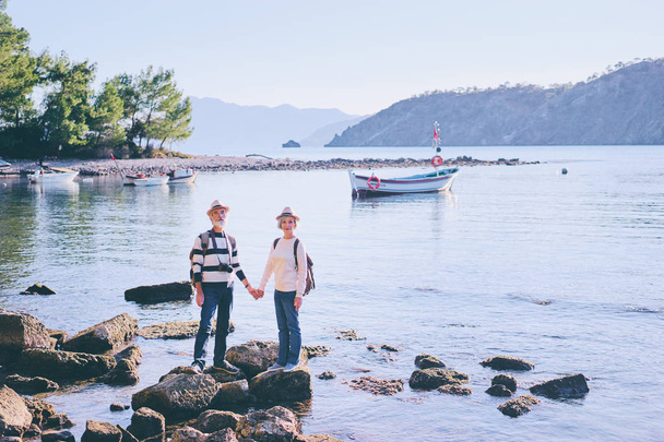 Senior family couple walking together on Mediterranean sea beach. - 写真・画像