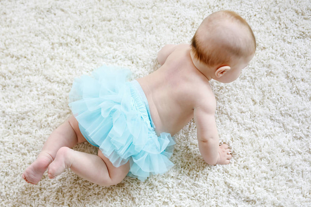 Adorable baby girl on white background wearing turquoise tutu skirt. - Photo, Image