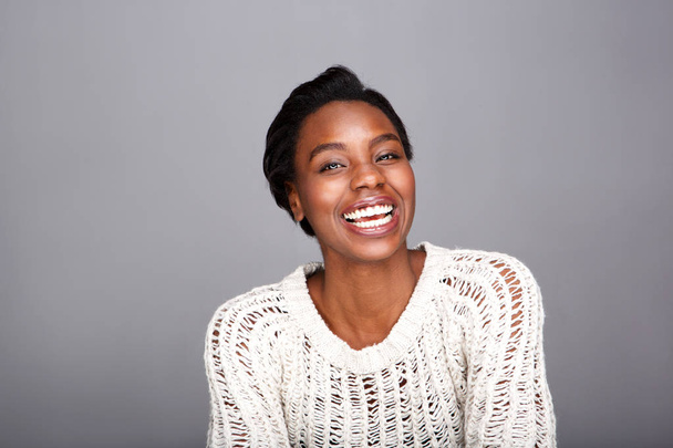 Close up portrait of attractive laughing black woman in white sweater - Photo, Image