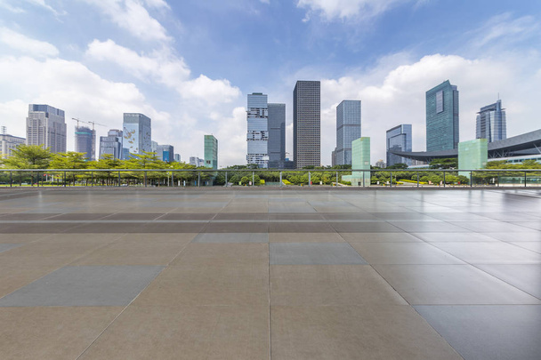 Skyline panoramique et immeubles de bureaux modernes avec route vide, plancher carré en béton vide - Photo, image
