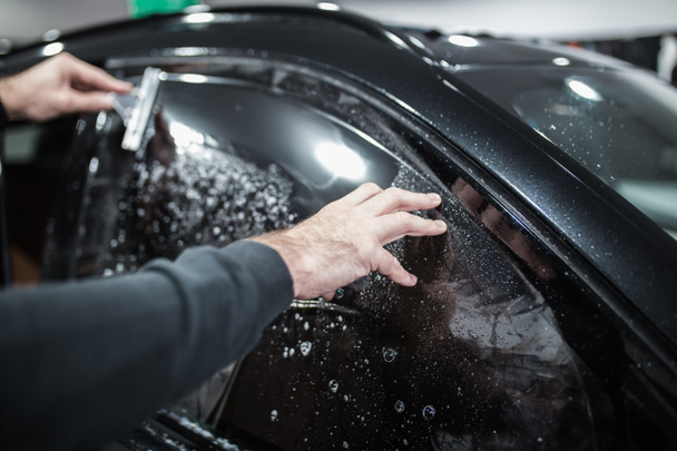 specialist does window tinting in the car - Фото, зображення