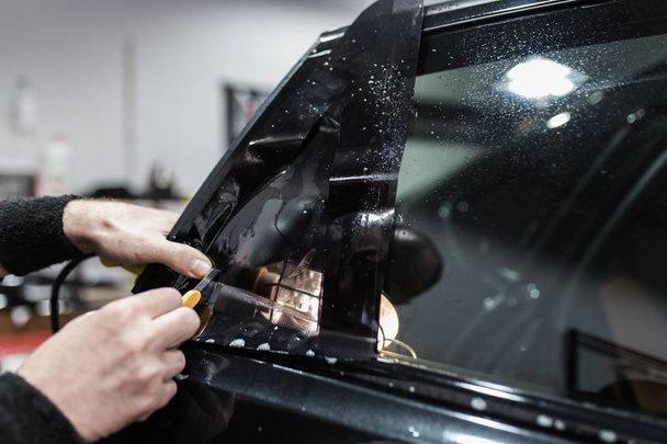 specialist does window tinting in the car - Photo, image