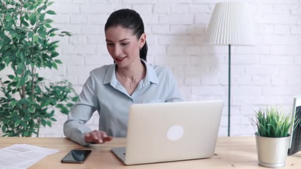 woman use laptop and smart phone on desk in office place - Felvétel, videó