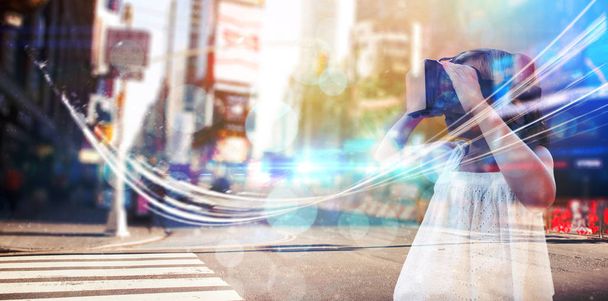 Girl wearing virtual reality simulator against blurry new york street - Foto, immagini