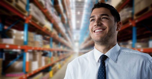 Digital composite of Businessman smiling successfully in warehouse perspective - Fotó, kép