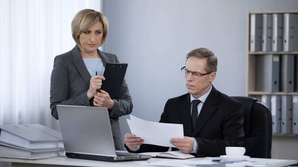 Subordinate office woman feeling uncomfortable at meeting with boss, wrong job - 写真・画像