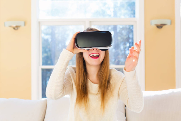 Young woman using virtual reality headset - Фото, зображення