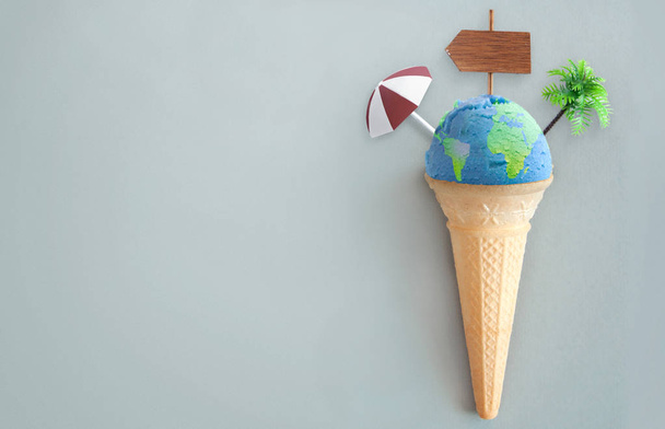 Ice cream scoop with world map and vacation items including beach post, parasol and palm tree - Фото, зображення