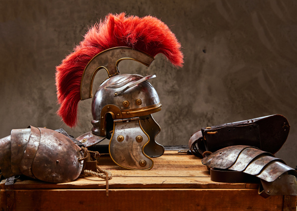 Die komplette Kampfausrüstung des antiken griechischen Kriegers liegt auf einer Holzkiste. - Foto, Bild