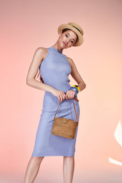 Sexy brunette woman wear skinny blue cotton dress silk summer collection perfect body shape diet skin tan hold accessory hat glamour model fashion catalog clothes date party walk bag party fun date. - 写真・画像