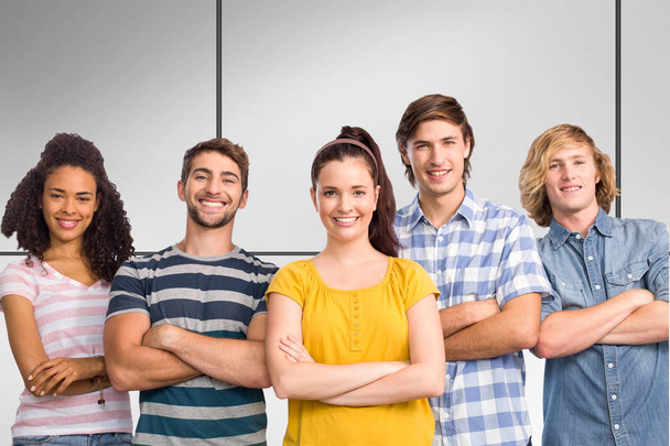 Happy college students with arms crossed against white tiling - Foto, Imagem