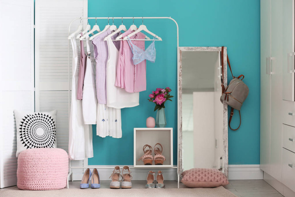 Stylish dressing room interior with clothes rack and mirror - 写真・画像