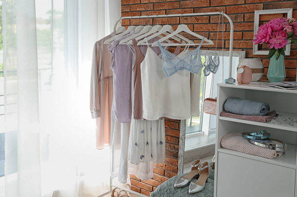 Stylish dressing room interior with clothes on rack - Φωτογραφία, εικόνα