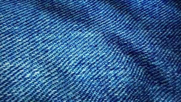 Blue background, denim jeans background. Jeans texture, fabric. texture of the material from the color of dark blue jeans with patches - Footage, Video