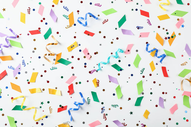Colorful confetti and streamers on white background, top view - Φωτογραφία, εικόνα
