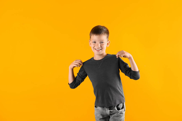 Little boy in long sleeve t-shirt on color background. Mock-up for design - Foto, Bild