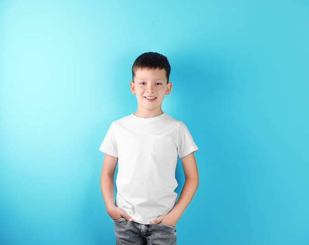 Little boy in t-shirt on color background. Mock-up for design - Zdjęcie, obraz